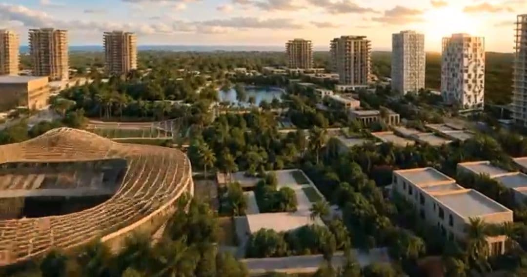 Render arquitectónico de un complejo de desarrollo urbano con torres residenciales, espacios verdes, lago artificial y edificios comerciales al atardecer.